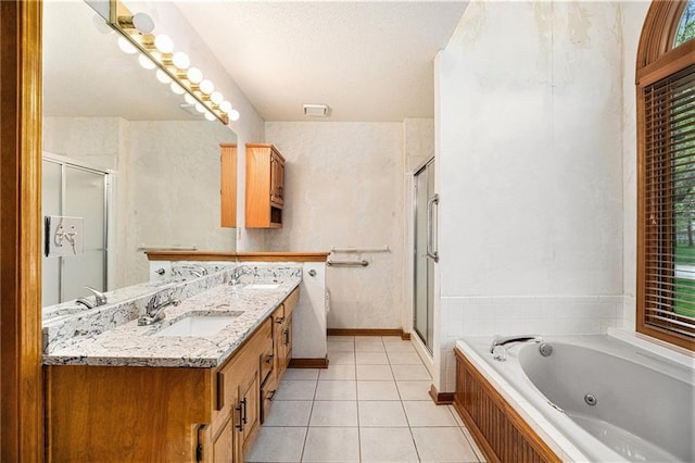 full bathroom with a tub with jets, a stall shower, a sink, and tile patterned floors