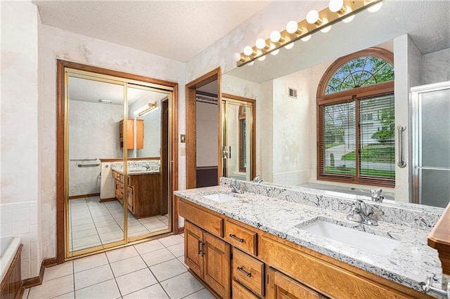 bathroom featuring double vanity, a sink, tile patterned floors, and visible vents