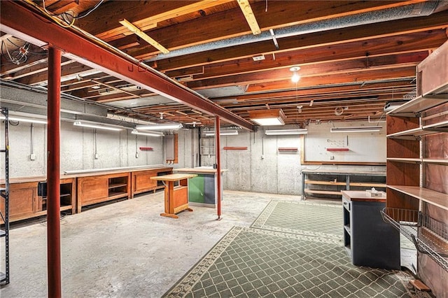 unfinished below grade area featuring a workshop area