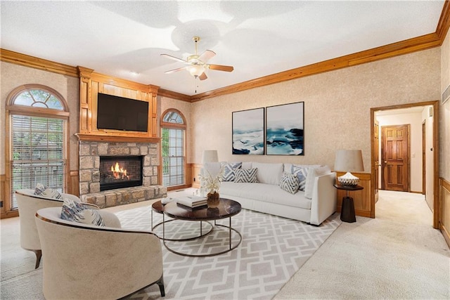 3212 N 110th St, Kansas City, KS 66109 - living area with crown molding, light colored carpet, a ceiling fan, and a stone fireplace