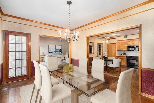 3212 N 110th St, Kansas City, KS 66109 - dining room with ornamental molding, wood finished floors, a chandelier, baseboards, and ceiling fan