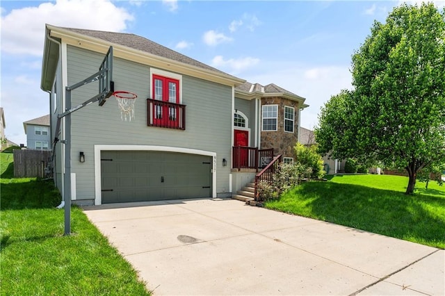 view of front of house with a garage, a front yard, and driveway