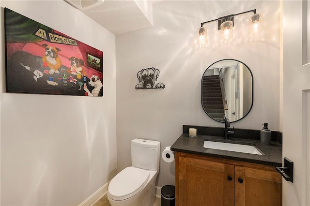 half bath featuring toilet and vanity