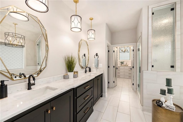 bathroom with tile patterned flooring, a sink, double vanity, and a stall shower