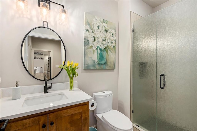 full bathroom featuring a shower stall, toilet, and vanity