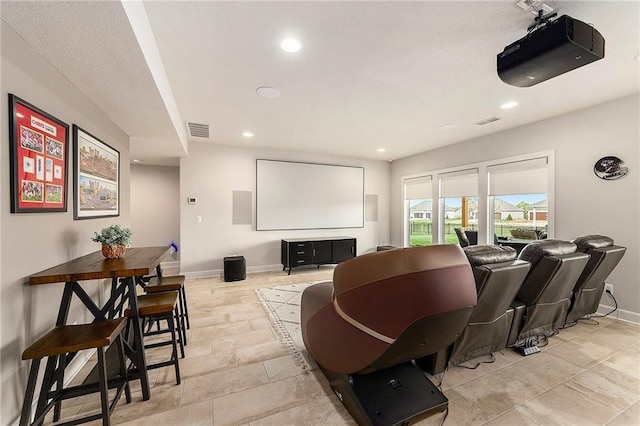 home theater with baseboards, visible vents, and recessed lighting