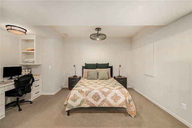 bedroom with baseboards and light colored carpet