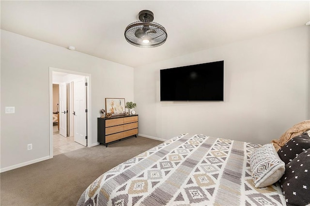 bedroom with ensuite bath, carpet flooring, and baseboards