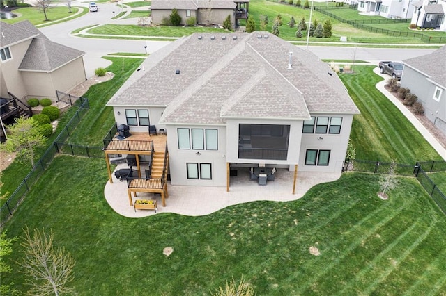 rear view of property with stairway, a deck, a shingled roof, a fenced backyard, and stucco siding