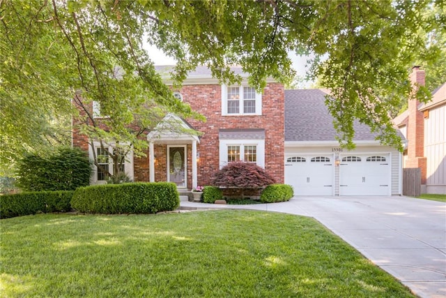 view of front of property featuring concrete driveway, an attached garage, a front lawn, brick siding, and roof with shingles