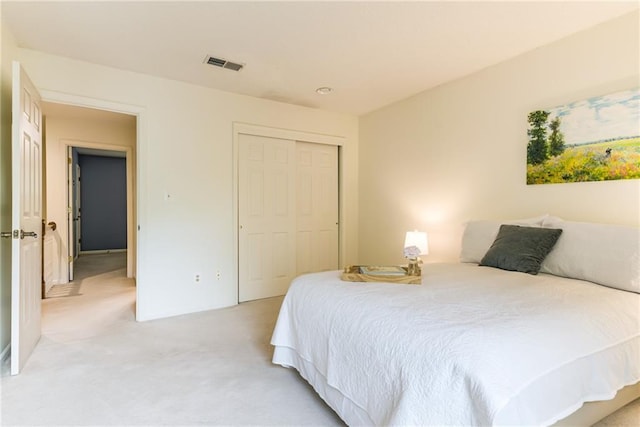 bedroom with light carpet and a closet