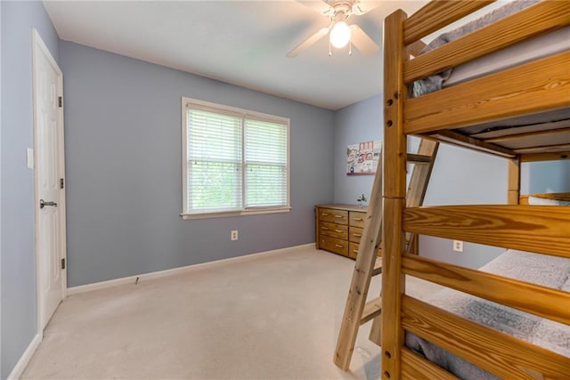 unfurnished bedroom with carpet floors, baseboards, and a ceiling fan
