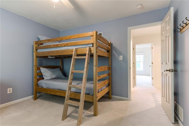 carpeted bedroom with baseboards and ceiling fan
