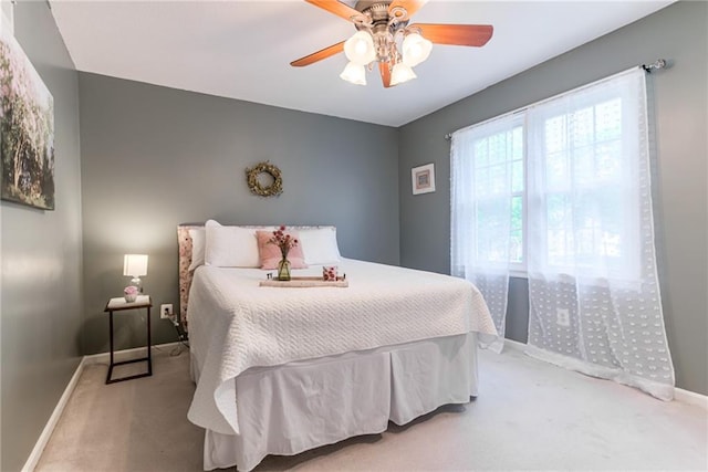 bedroom featuring carpet, baseboards, and ceiling fan