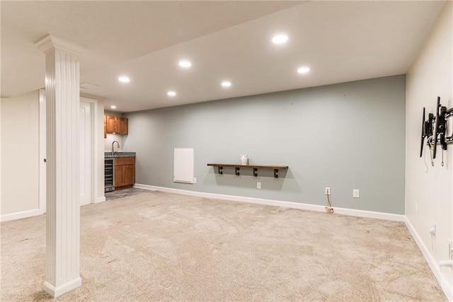 finished basement with light colored carpet, recessed lighting, wet bar, wine cooler, and baseboards