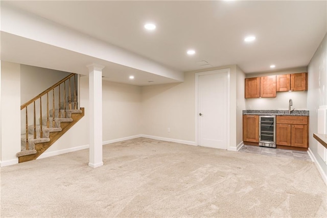 indoor wet bar featuring wine cooler, light carpet, baseboards, and recessed lighting