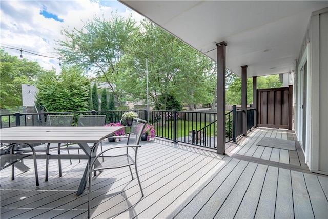 wooden deck featuring outdoor dining area