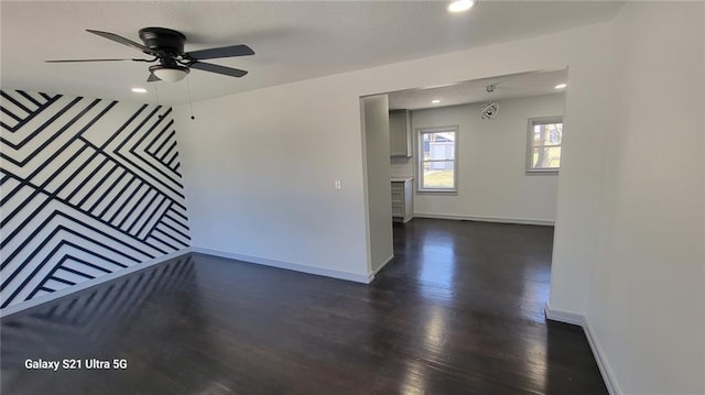 spare room with baseboards, recessed lighting, dark wood finished floors, and a ceiling fan