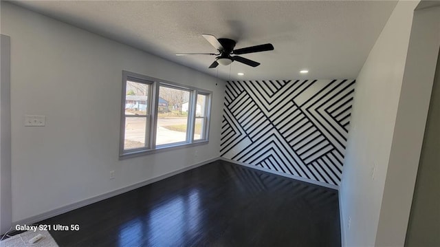 spare room with dark wood-style floors, baseboards, a ceiling fan, a textured ceiling, and recessed lighting