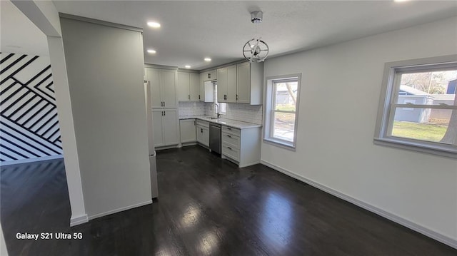 kitchen with a sink, dishwasher, healthy amount of natural light, dark wood-type flooring, and recessed lighting