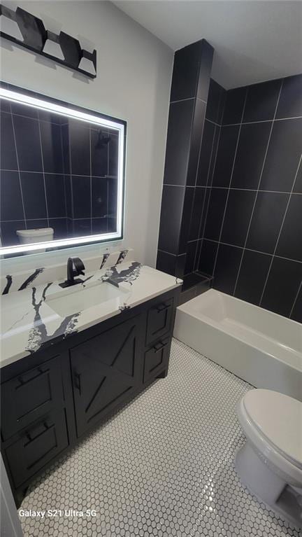 bathroom featuring toilet, a shower, vanity, and tile patterned flooring
