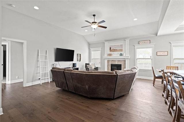 1002 Fox Trot Dr, Odessa, MO 64076 - living room with a ceiling fan, a tiled fireplace, dark wood finished floors, baseboards, and lofted ceiling