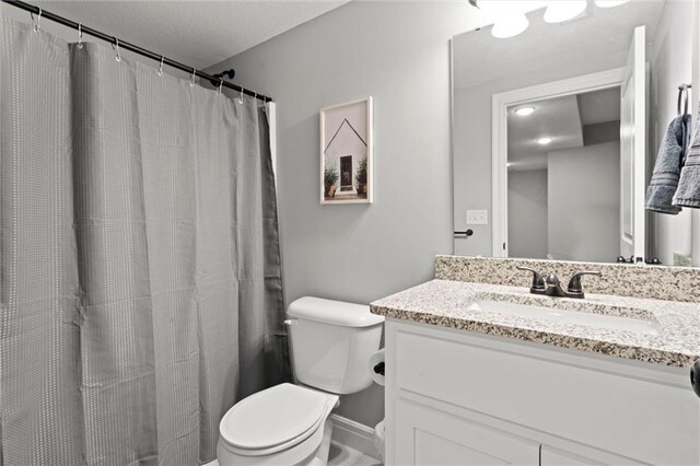 1002 Fox Trot Dr, Odessa, MO 64076 - bathroom with toilet, vanity, baseboards, curtained shower, and a textured ceiling