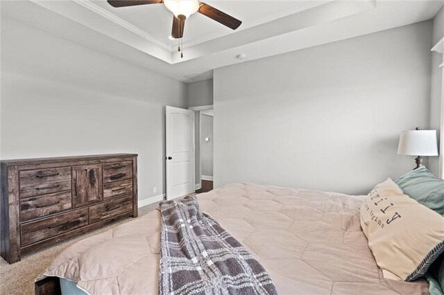 1002 Fox Trot Dr, Odessa, MO 64076 - bedroom featuring a tray ceiling, crown molding, a ceiling fan, and carpet floors