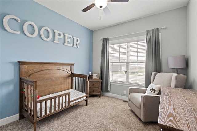 1002 Fox Trot Dr, Odessa, MO 64076 - carpeted bedroom with baseboards, a nursery area, and a ceiling fan