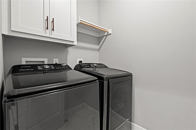 1002 Fox Trot Dr, Odessa, MO 64076 - laundry area with washer and clothes dryer, cabinet space, and baseboards