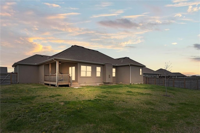 1002 Fox Trot Dr, Odessa, MO 64076 - back of house at dusk with a wooden deck