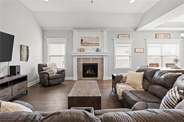 1002 Fox Trot Dr, Odessa, MO 64076 - living area with vaulted ceiling, dark wood-type flooring, a tiled fireplace, baseboards, and recessed lighting