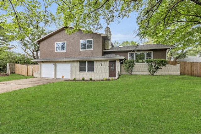 tri-level home with fence, an attached garage, a chimney, and a front yard