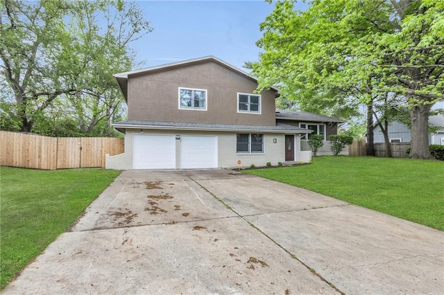 split level home featuring a garage, fence, concrete driveway, and a front yard