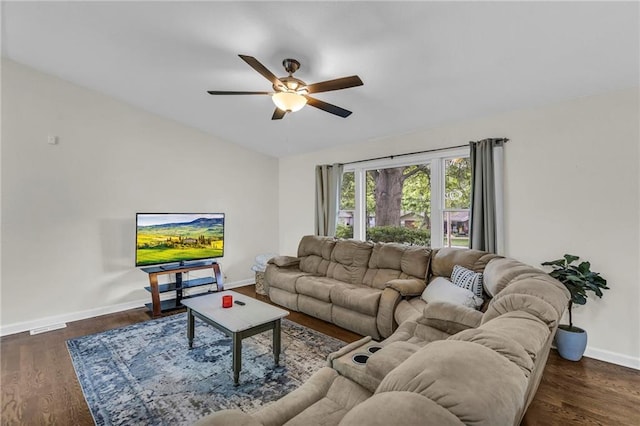 living area featuring baseboards, a ceiling fan, and wood finished floors