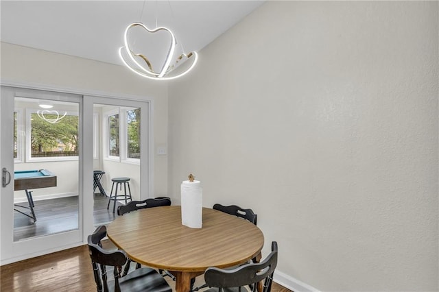 dining space with baseboards and dark wood-type flooring