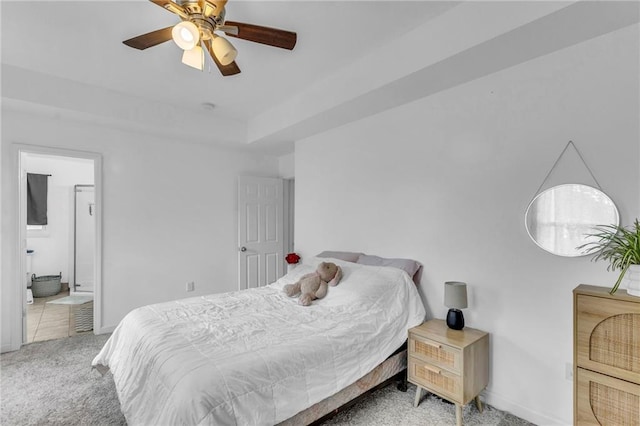 carpeted bedroom featuring baseboards, a ceiling fan, and ensuite bath