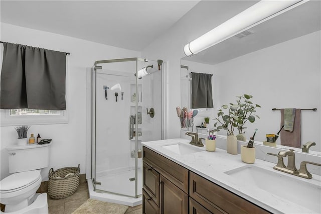 full bathroom with a sink, tile patterned floors, a stall shower, and toilet