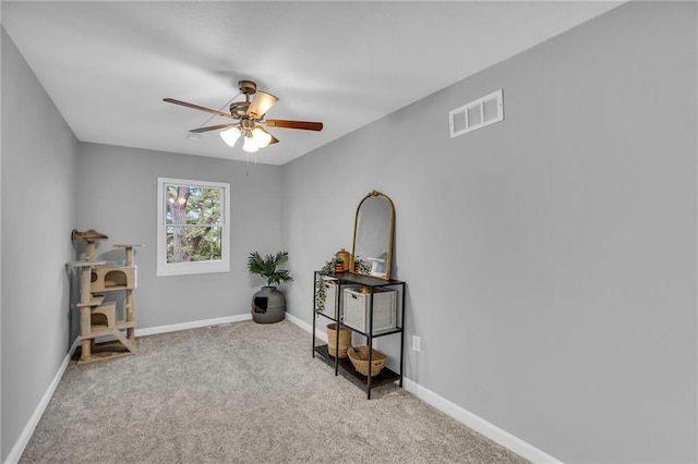 miscellaneous room with baseboards, carpet, a ceiling fan, and visible vents