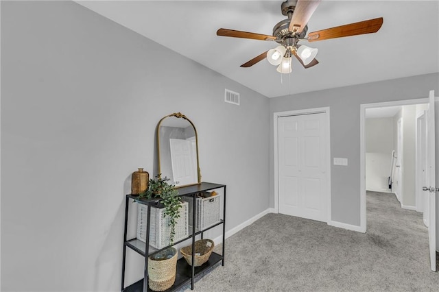 carpeted bedroom with visible vents, baseboards, and ceiling fan