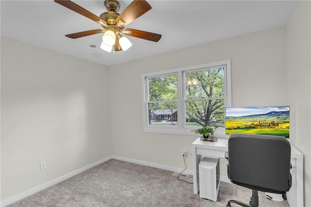 home office with baseboards, a ceiling fan, and carpet