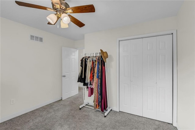 bedroom featuring ceiling fan, visible vents, carpet floors, baseboards, and a closet