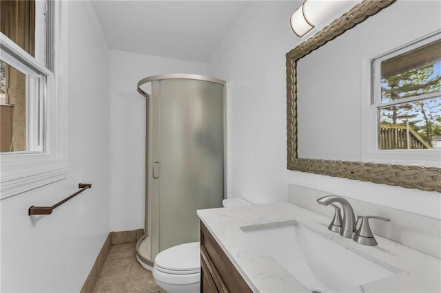 full bath featuring vanity, toilet, baseboards, tile patterned floors, and a stall shower