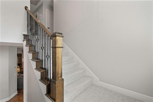 staircase featuring baseboards
