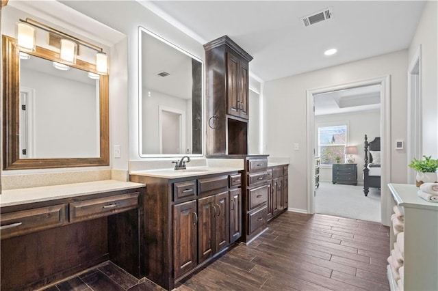 bathroom with hardwood / wood-style flooring, vanity, and recessed lighting