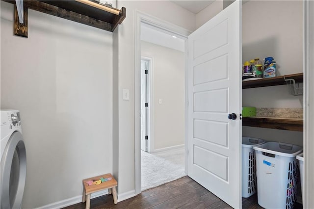 clothes washing area featuring washer / dryer, dark wood-style flooring, and baseboards