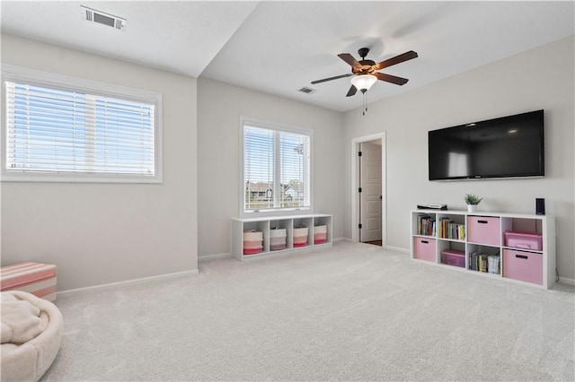 sitting room featuring baseboards, ceiling fan, and carpet flooring