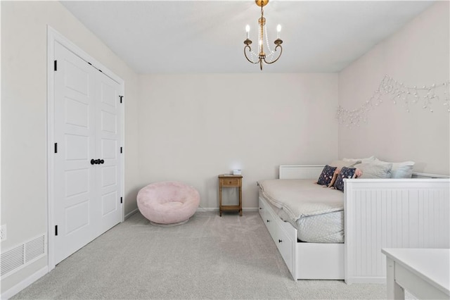 bedroom with light colored carpet and baseboards