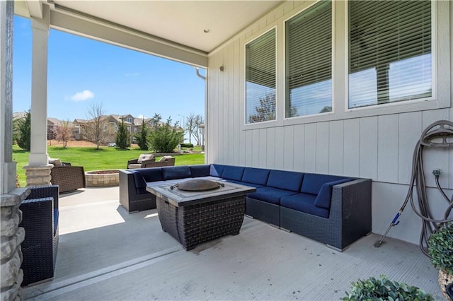 view of patio featuring an outdoor living space with a fire pit