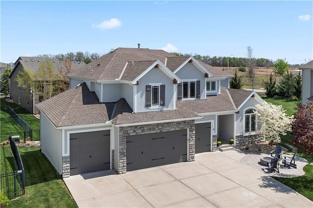 view of front of property with concrete driveway, stone siding, stucco siding, and an attached garage